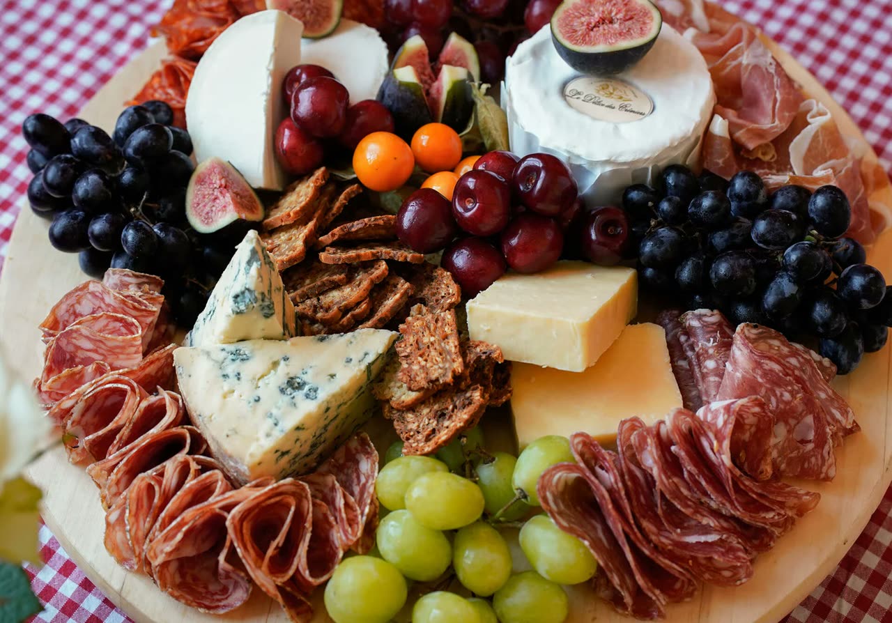 Charcuterie, cheese, figs and grapes on a board