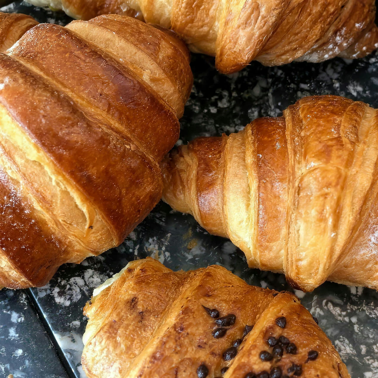 Golden croissants and pain aux raisins fresh from the oven