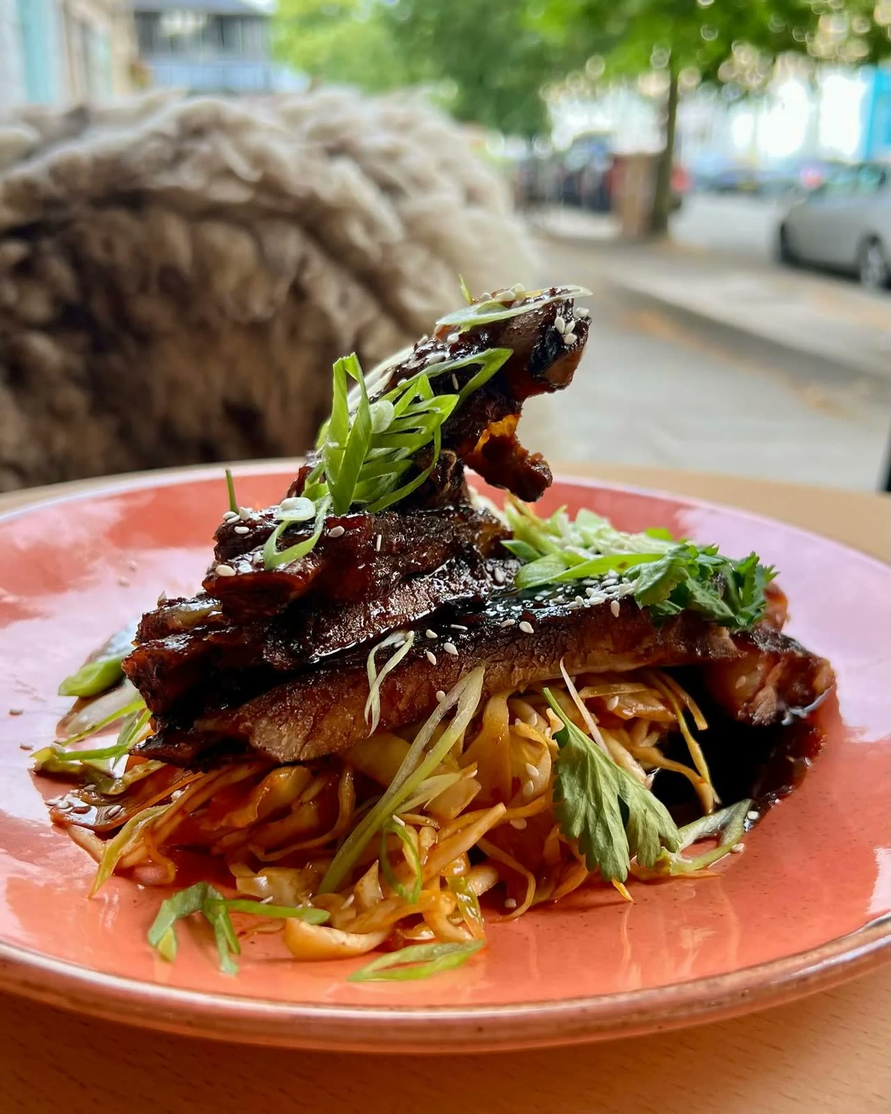 Ribs in gochujang sauce on a bed of kimchi slaw