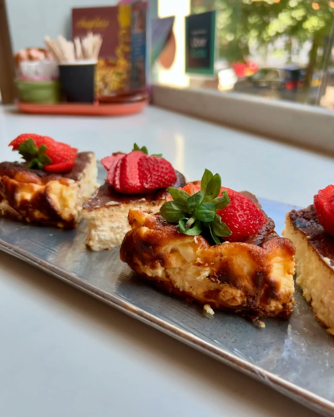 Slices of burnt basque cheesecake with strawberries