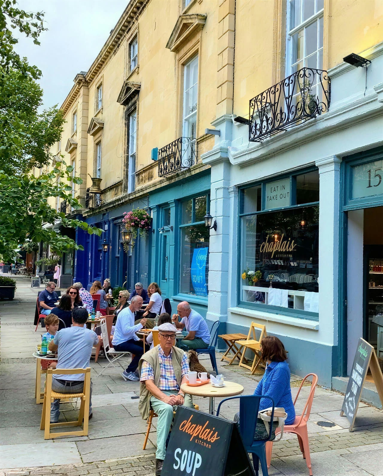Customers at the tables outside Chaplais Kitchen on a summer afternoon in Montpellier